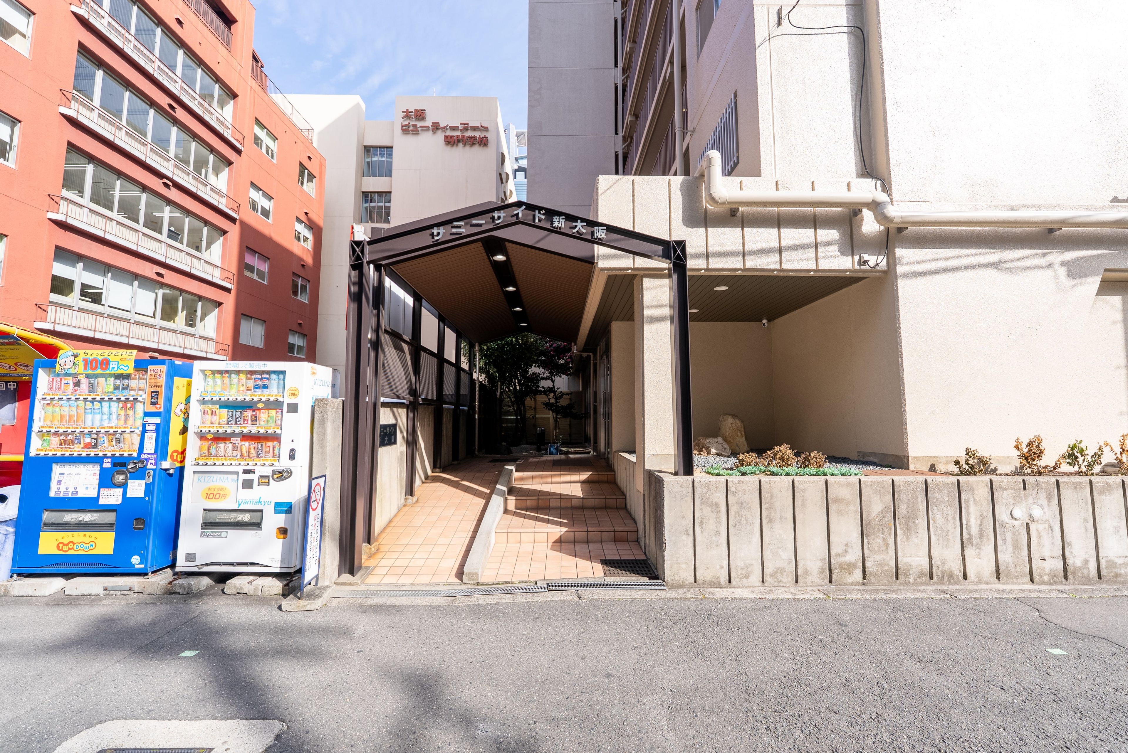 A building entrance with a covered walkway leading to a building entrance.