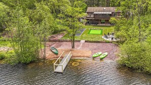 A lakeside lodge with a dock, kayaks, and a tennis court. - New to VRBO! Lakefront I Movie Theater I Putting Green I Game Room I Bocce ball! (White Haven)