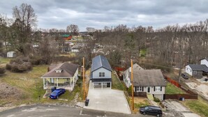 A residential area with houses, a garage, and a driveway.