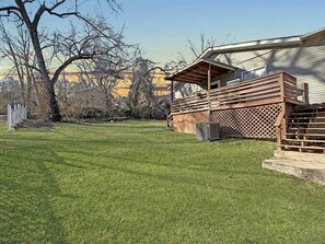 A residential property with a well-maintained lawn, a wooden deck, and a detached garage. - Two Homes walk to Convention Ctr Hot Tub Game room (Branson)