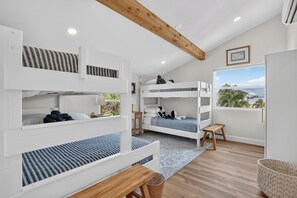 A bunk bed room with a view of the outdoors. - 45 sec to Beach Access • Gulf Views • Pool+Spa • Bikes+Putting Green ... (Anna Maria)