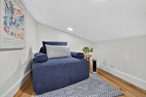 A bedroom with a bed, a small table with a plant, and a wall-mounted heater. - 45 sec to Beach Access • Gulf Views • Pool+Spa • Bikes+Putting Green ... (Anna Maria)