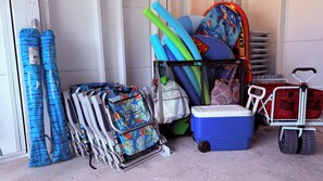 A storage area with various items including rolled-up mats, a cooler, and a cart with bags. - 45 sec to Beach Access • Gulf Views • Pool+Spa • Bikes+Putting Green ... (Anna Maria)