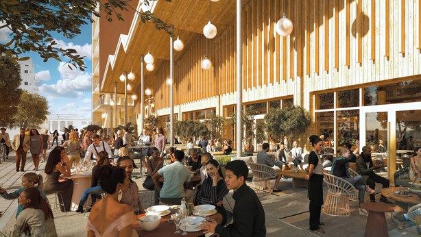 An outdoor dining area with tables and chairs, surrounded by a building with large windows and wooden slats. - Le Pic Coliving (Clermont-Ferrand)