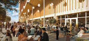 An outdoor dining area with tables and chairs, surrounded by a building with large windows and wooden slats. - Le Pic Coliving (Clermont-Ferrand)