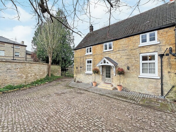 A stone house with a tiled courtyard, a small porch, and a chimney. - The perfect base for exploring, relaxing and making unforgettable memories. (Burton, near Lincoln)