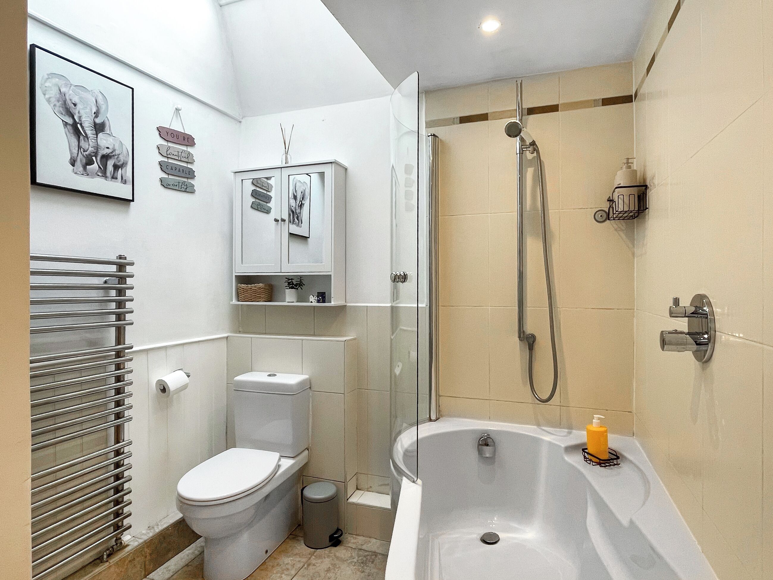 A modern bathroom with a toilet, bidet, shower, and a bathtub.