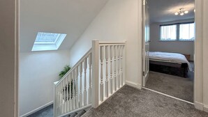 Une chambre à coucher avec un lit, une lucarne et une fenêtre.