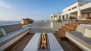 A rooftop terrace with a fire feature, outdoor seating, and a view of the sea. - Villa Verdessa, Divine Sea Views, Private Infinity Pool, Furnished Terrace,. (Crete)