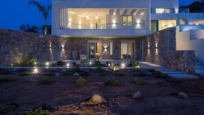 A modern two-story house with a stone facade, large windows, and a well-lit entrance. - Villa Verdessa, Divine Sea Views, Private Infinity Pool, Furnished Terrace,. (Crete)