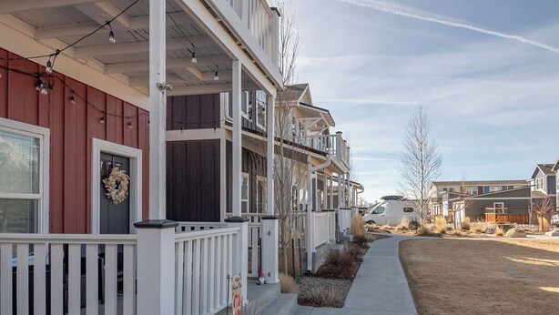 A row of townhouses with a covered porch, a concrete pathway, and a clear sky. - Mt. Princeton Views. Remodeled. Fire Pit & BBQ (Buena Vista)