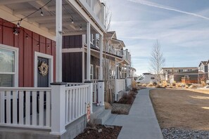 A row of townhouses with a covered porch, a concrete pathway, and a clear sky. - Mt. Princeton Views. Remodeled. Fire Pit & BBQ (Buena Vista)