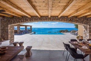 A stone-arched patio with a pool and lounge chairs, overlooking a clear blue sea. - Villa Terrissa, Divine Sea Views, Private Pool, Furnished Terrace, Arvi (Crete)