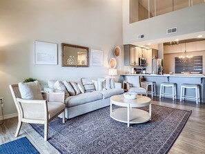 A modern living room with a sofa, chairs, a coffee table, and a patterned rug. - Heavenly Pointe | Penthouse Lake Views, Elevator, Accessible, King Beds (Branson)