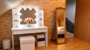 A room with a vanity, mirror, and wooden flooring. - Village house in a quiet location, green oasis vacation home (Hefersweiler)