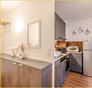 A modern kitchen with a wooden countertop, a microwave, and a sink.