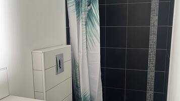 Shower, hair dryer, towels, toilet paper