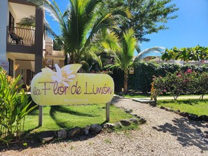 A sign for 'la Flor de Limón' indicating a residential property. - Tropical 2nd floor Condo with Rooftop (Playas Del Coco)