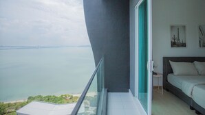A balcony with a view of a body of water and a bridge. - QuayWest (George Town)