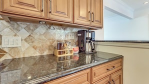 A kitchen with wooden cabinets, a marble backsplash, a coffee maker, and a spice rack. - 26 Mi to Metlife & Nyc: 1 mi to Train (Scotch Plains)