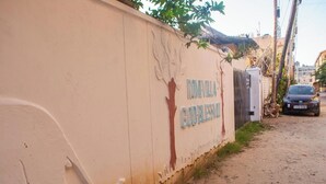 A wall with the inscription "ROME-VILLA GOOD BLESSING" and a tree design. - Marve 408 Stylish Studio Apartment (Mtwapa)