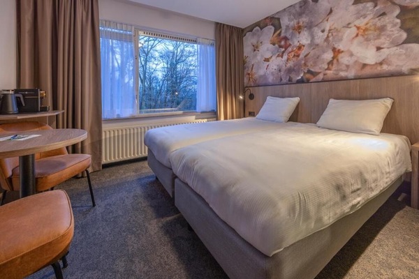 Sink into crisp twin beds beside serene woodland views.