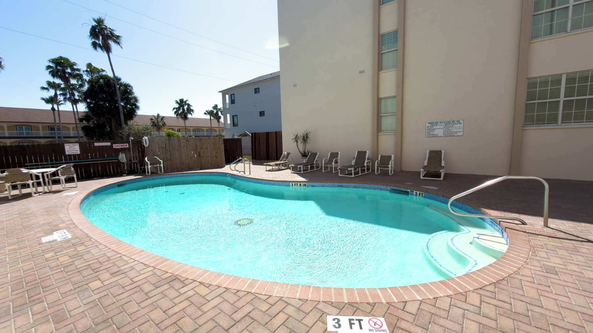 A 3 FT 9 IN pool with lounge chairs and a wooden fence.