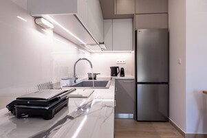 Luxury Duplex, Partial Sea View | Private kitchen | Full-size fridge, oven, espresso maker, coffee/tea maker