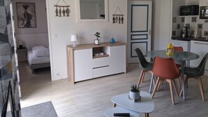 Ett modernt vardagsrum med matplats, kök och sovrum.