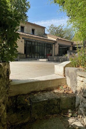 A building with a tiled roof, large windows, and a courtyard. - Country house near St Emilion (Montcaret)