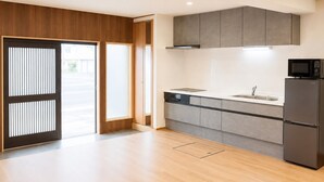 A modern kitchen with grey cabinets, a built-in microwave, and a dishwasher.