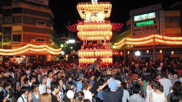 A crowded street with a large illuminated lantern structure.