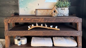 A rustic wooden shelf with a framed artwork, a potted plant, and a birdhouse. - Secluded and romantic:  The perfect glamping getaway guests are loving! (Siloam Springs)