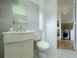 Ein Badezimmer mit Waschbecken, Spiegel und Toilette.