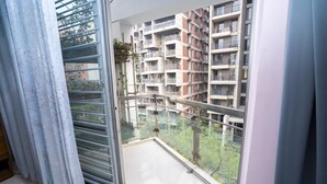 A balcony with a view of a multi-story residential building. - Spacious 3BR Apartment in Dhanmondi (Dhaka)