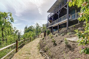 A modern building with a wooden deck and a stone retaining wall. - New from 5 Star Hosts-Panoramic Mtn Views-Private-Peaceful on 5 acres-Convenient (Weaverville)