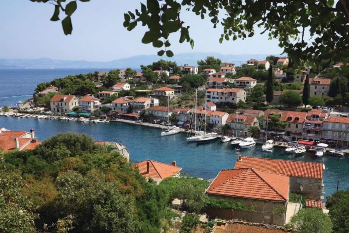 A coastal town with buildings, a marina, and boats.