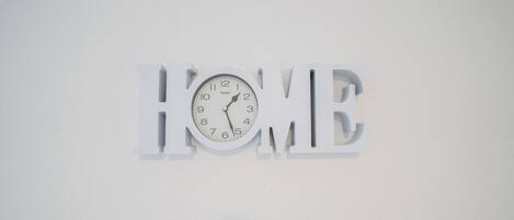 A wall clock with the word "HOME" integrated into its design.