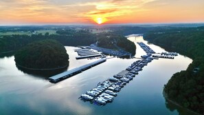 A marina with multiple docks and boats, surrounded by greenery and a river. - Spacious 3-Bed Townhome in Charming Somerset with the Ideal Location. (Somerset)