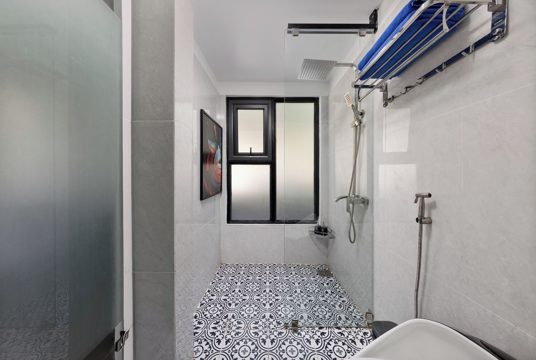 A bathroom with a shower, a bathtub, and a window.
