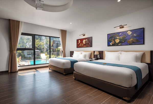 A hotel room with two beds, a large window with a view of a pool, and two paintings on the wall.