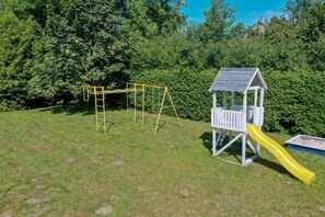 A playground with a yellow slide and a climbing structure. - Comfortable Holiday Villa With Terrace and Garden (Krokowa)