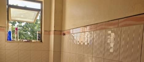 Deluxe Apartment, City View | Bathroom | Shower, free toiletries, slippers, towels