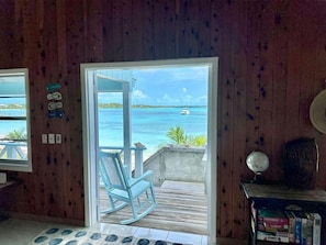 A wooden interior with a view of the ocean and a boat.