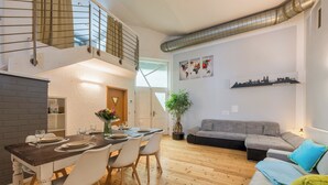 A modern apartment with a dining area, a living room, and a staircase. - Spacious ground floor loft with 140 m² - ideal for families & groups of up to 6 (7) people (Magdeburg)