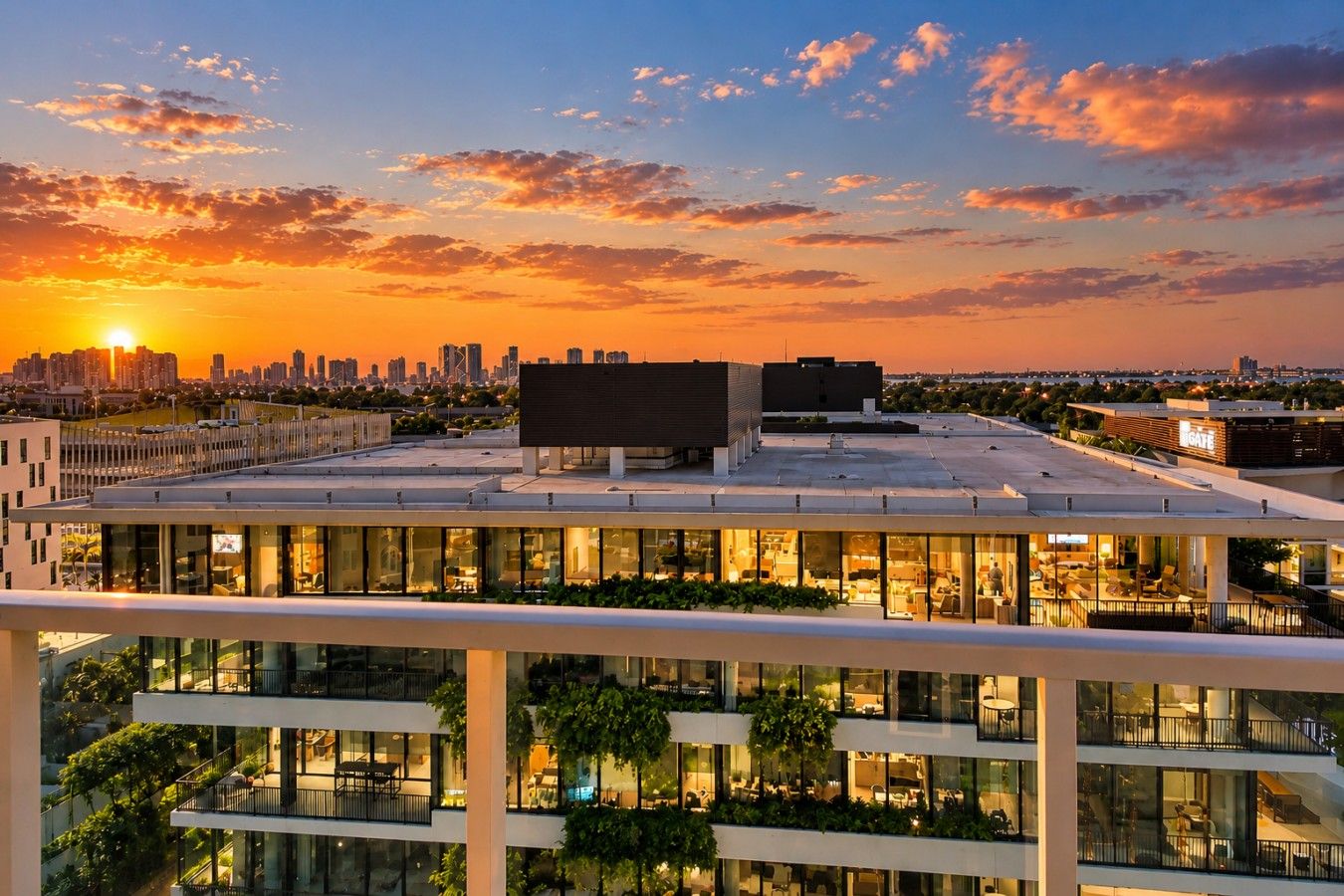 A modern building with multiple floors, large windows, and a rooftop terrace.