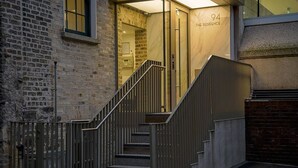 A staircase leading to a building entrance with a sign reading "THE RESIDENCE 94". - Elegant City 1BR at St Stephen's Green (Dublin)