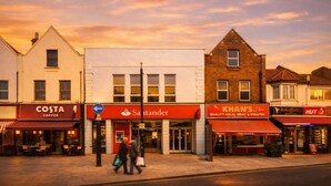 A street view with Costa Coffee, Santander bank, Khan's Halal Meat & Poultry, and a BeKoffeez cafe. - Convenient 3BR Apartment near ExCel, O2 Arena w/Parking, Link to Central London (London)