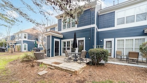 A two-story house with a patio area featuring outdoor furniture and a covered seating area. - Tuscany Lane Townhouse - 2 floors, Near Lake, Pool, Pets OK - LKN Location (Cornelius)