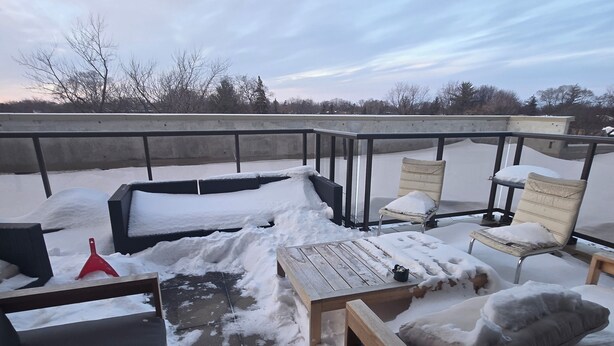 An outdoor seating area with snow-covered furniture and a view of trees and a cloudy sky. - Unique One Bedroom with VIP Terrace in Yonge & Eglinton and 5 minutes to Subway (Toronto)